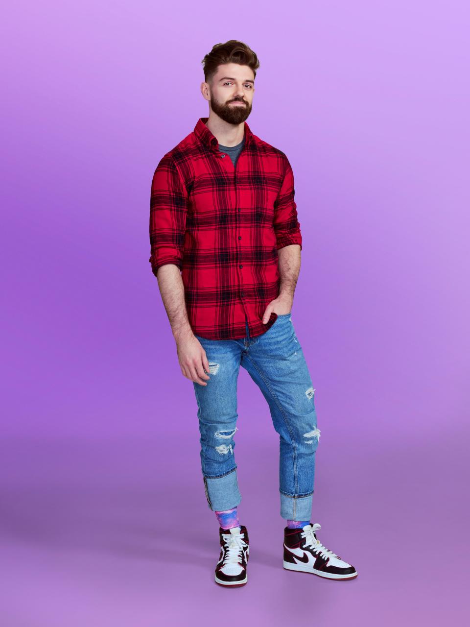 Austin, a candidate at "Love is blind" Season 6, wearing a red and black shirt and jeans