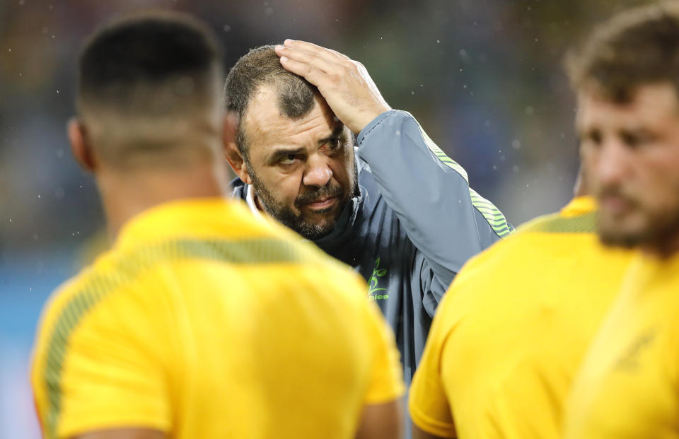 Australia coach Michael Cheika watches as his players warm up ahead of the Rugby World Cup Pool D game at Shizuoka Stadium Ecopa between Australia and Georgia in Shizuoka, Japan, Friday, Oct.11, 2019. (AP Photo/Christophe Ena)