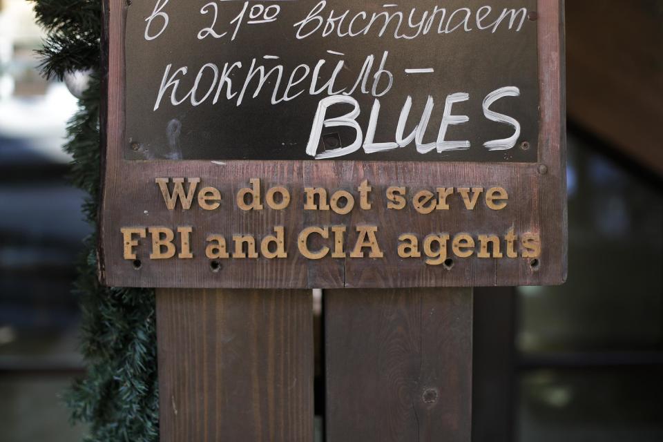 A sign that says "We do not serve FBI and CIA agents," hangs outside a restaurant on the opening day of the 2014 Winter Olympics, Friday, Feb. 7, 2014, in Krasnaya Polyana, Russia. (AP Photo/Jae C. Hong)