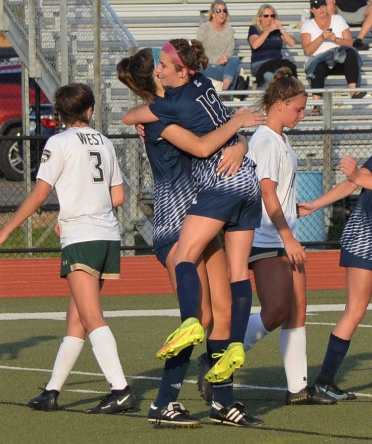 After Mackenzie Ford scored on a penalty kick to give Gull Lake a 2-1 lead, Aleah Minehart jumps into her arms during this Division 2 regional title game at Harper Creek High School on Friday.