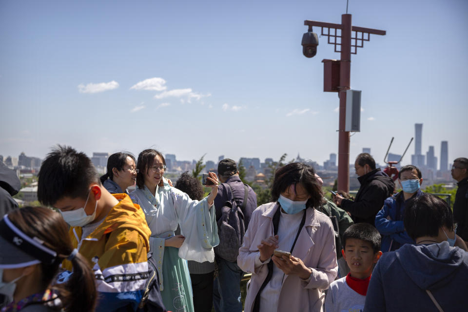 Visitors gather at a viewing area at a public park in Beijing, Saturday, May 1, 2021. Chinese tourists are expected to make a total of 18.3 million railway passenger trips on the first day of the country's five-day holiday for international labor day, according to an estimate by the state railway group, as tourists rush to travel domestically after the coronavirus has been brought under control in China. (AP Photo/Mark Schiefelbein)