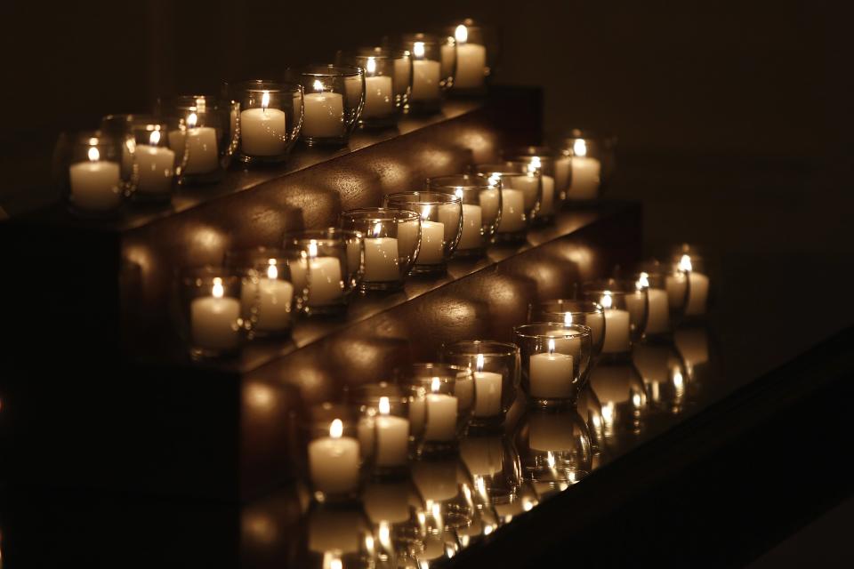 Twenty-six candles remain lit after Obama and the first lady observed a moment of silence in memory of the 20 children and six school workers killed by a gunman at Sandy Hook Elementary School one year ago, in the Map Room at the White House in Washington