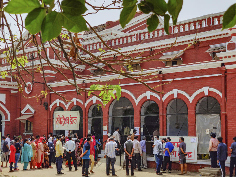 People wait in a queue to test for COVID-19 in Prayagraj, India, Thursday, April 8, 2021. India now has a seven-day rolling average of more than 80,000 cases per day and has reported 12.9 million coronavirus cases since the pandemic began, the highest after the United States and Brazil. (AP Photo/Rajesh Kumar Singh)