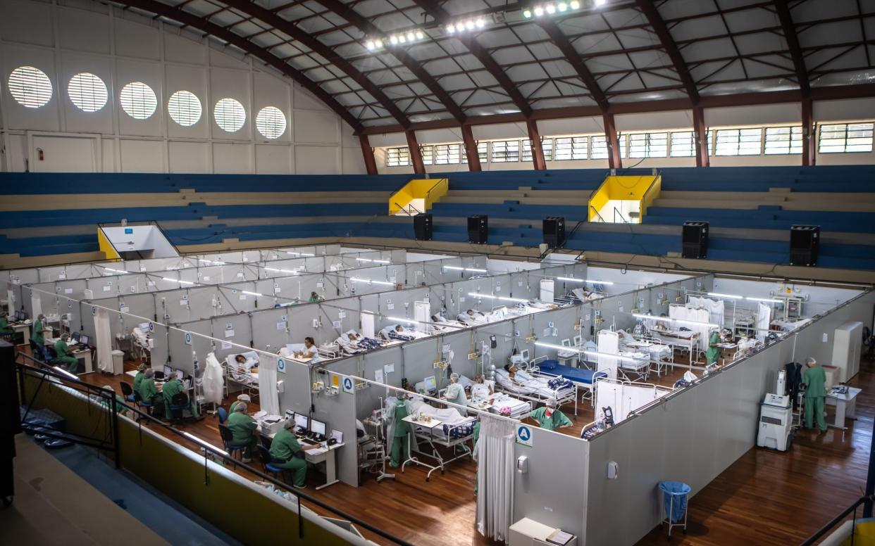 Healthcare workers treat Covid patients in a field hospital at the Pedro Dell'Antonia sports complex in Santo Andre, Brazil - Jonne Roriz/Bloomberg