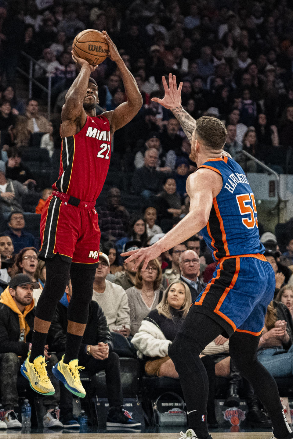 Miami Heat forward Jimmy Butler (22) shoots over New York Knicks center Isaiah Hartenstein (55) during the first half of an NBA basketball game, Saturday, Jan. 27, 2024, in New York. (AP Photo/Peter K. Afriyie)