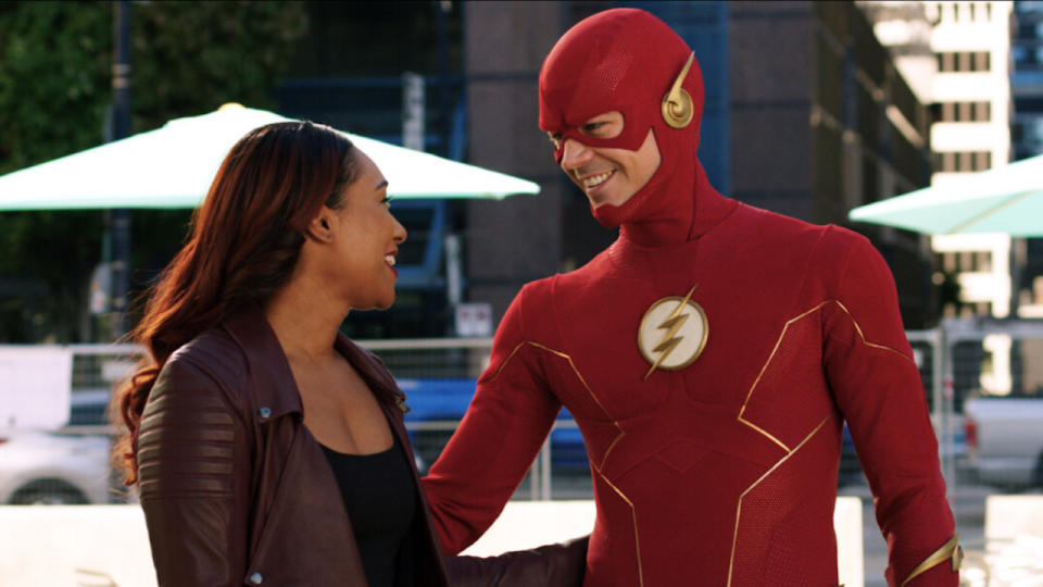 Grant Gustin and Candice Patton smiling at each other in The Flash