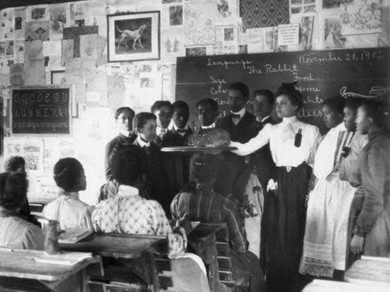 A woman wears a teaching pinafore to teach a science class at Tuskegee Institute in 1902 (Getty)