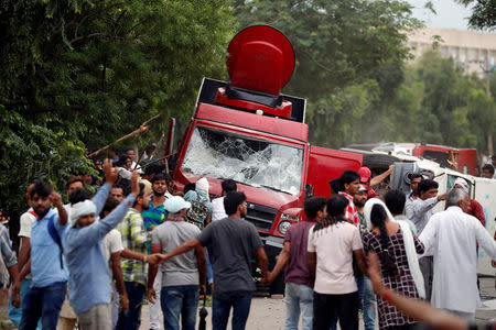 Rioters smash television trucks during violence in Panchkula, India, August 25, 2017. REUTERS/Cathal McNaughton