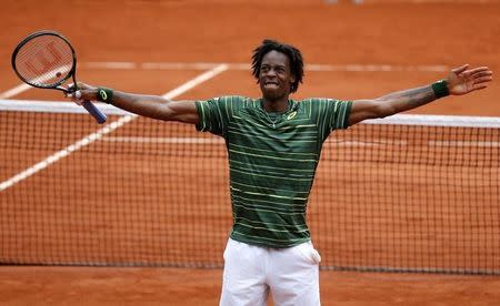 Gael Monfils of France celebrates after beating Pablo Cuevas of Uruguay during their men's singles match at the French Open tennis tournament at the Roland Garros stadium in Paris, France, May 29, 2015. REUTERS/Pascal Rossignol