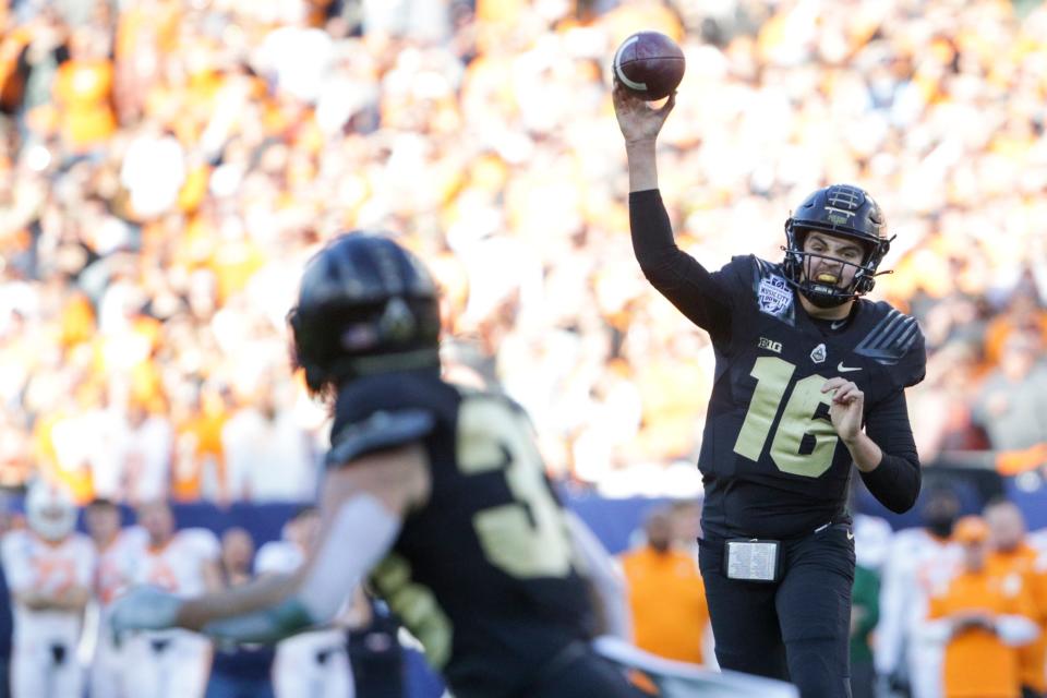 Purdue quarterback Aidan O'Connell (16) throws to Purdue wide receiver Jackson Anthrop (33) during the first quarter of the Music City Bowl, Thursday, Dec. 30, 2021, at Nissan Stadium in Nashville.