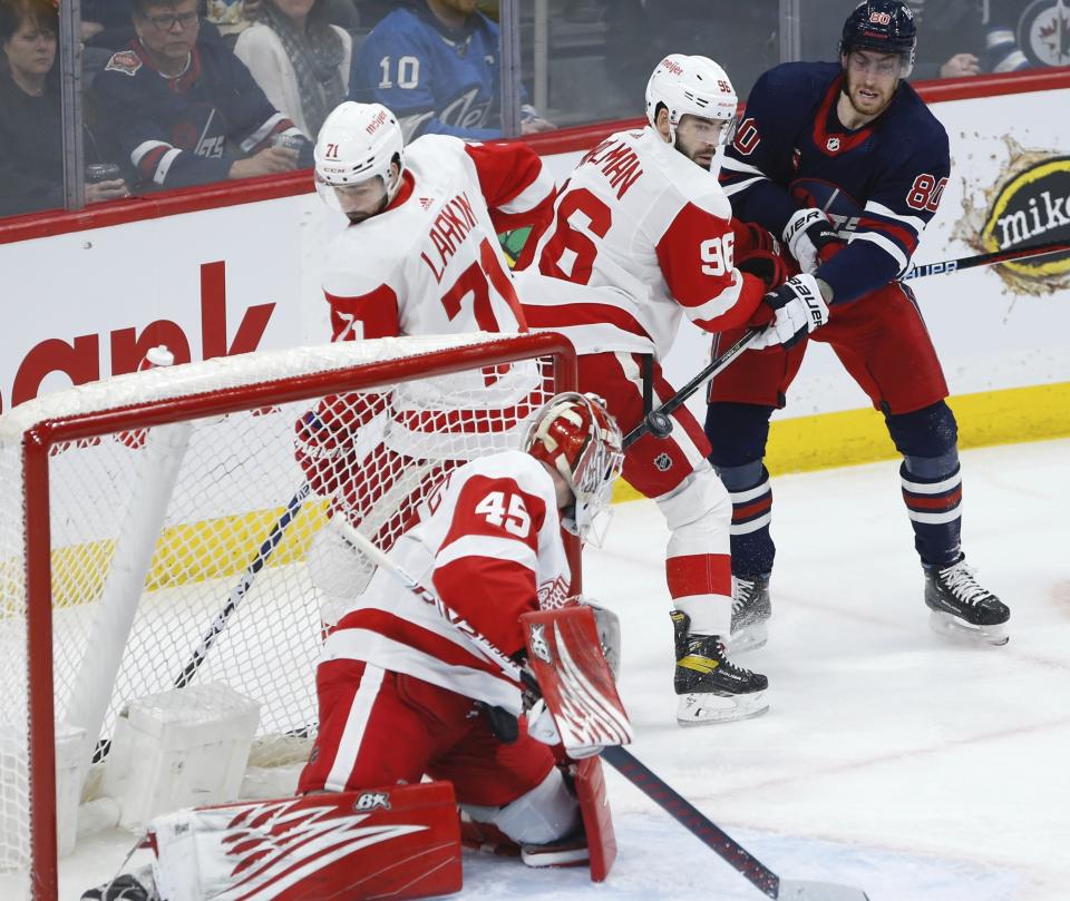 Winnipeg Jets' Pierre-Luc Dubois (80) watches as Detroit Red Wings goaltender Magnus Hellberg (45) saves his shot during first-period NHL hockey game action in Winnipeg, Manitoba, Friday, March 31, 2023. (John Woods/The Canadian Press via AP)
