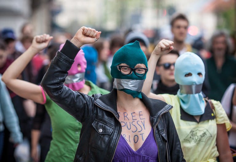 Supporters of the Russian punk band 'Pussy Riot' wear masks and tape their mouths shut as they protest in front of the Russian embassy in Warsaw on August 17, 2012. Moscow police made several arrests on Friday as dozens of activists staged a picket outside the headquarters of the Russian prison service on women's day to call for the punk rock group's release