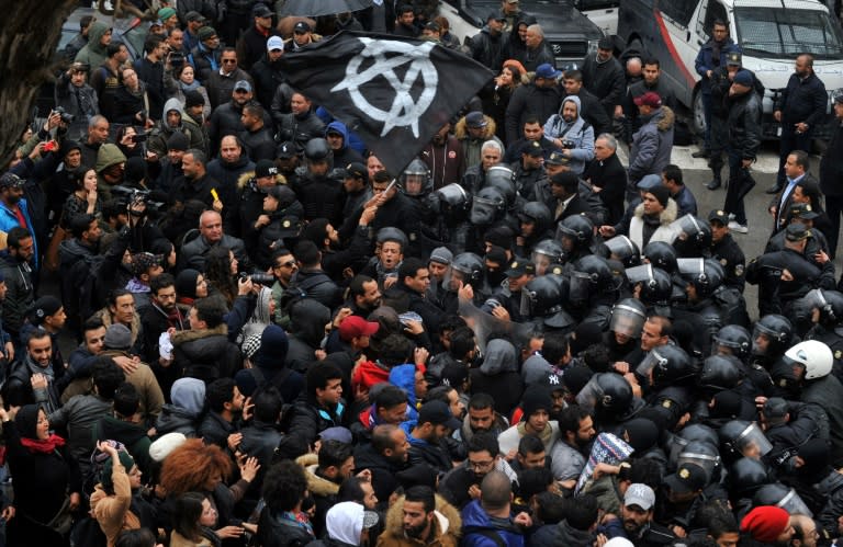 Protesters confront security forces in the Tunisian capital during a demonstration over price hikes and austerity measures on January 12, 2018