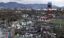 A view of destroyed houses after super Typhoon Haiyan battered Tacloban city in central Philippines November 9, 2013. Possibly the strongest typhoon ever to hit land devastated the central Philippine city of Tacloban, killing at least 100 people, turning houses into rubble and leveling the airport in a surge of flood water and high wind, officials said on Saturday. The toll of death and damage from Typhoon Haiyan on Friday is expected to rise sharply as rescue workers and soldiers reach areas cut off by the massive, fast-moving storm which weakened to a category 4 on Saturday. REUTERS/Erik De Castro (PHILIPPINES - Tags: DISASTER ENVIRONMENT)