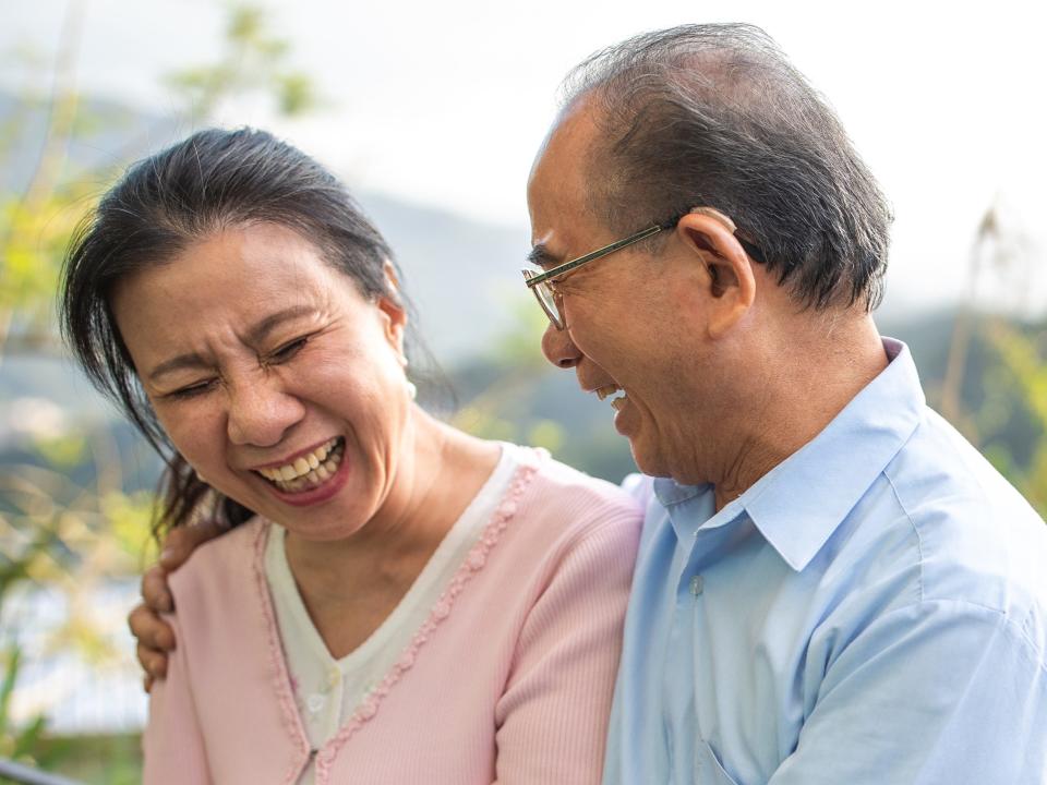 happy older couple hug