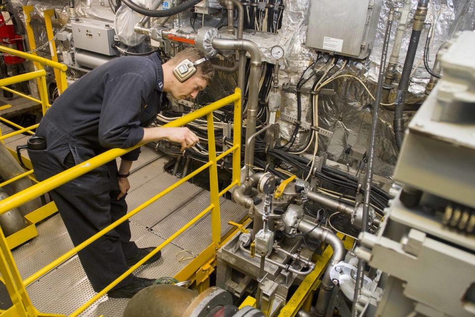 Lt. James Berry visually inspects an engine as the main propulsion assistant in preparation for Engineering Operations Certification aboard the littoral combat ship USS Coronado