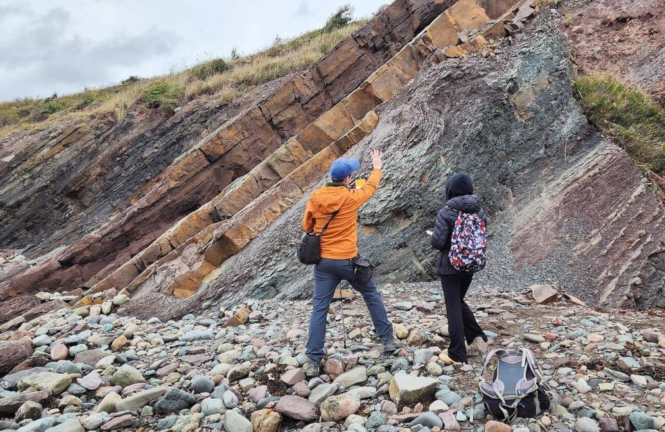 CBU geology professor Ted Matheson and student Jessica MacIsaac examine the landscape near Creignish, where Matheson first spotted the fossilized tracks.