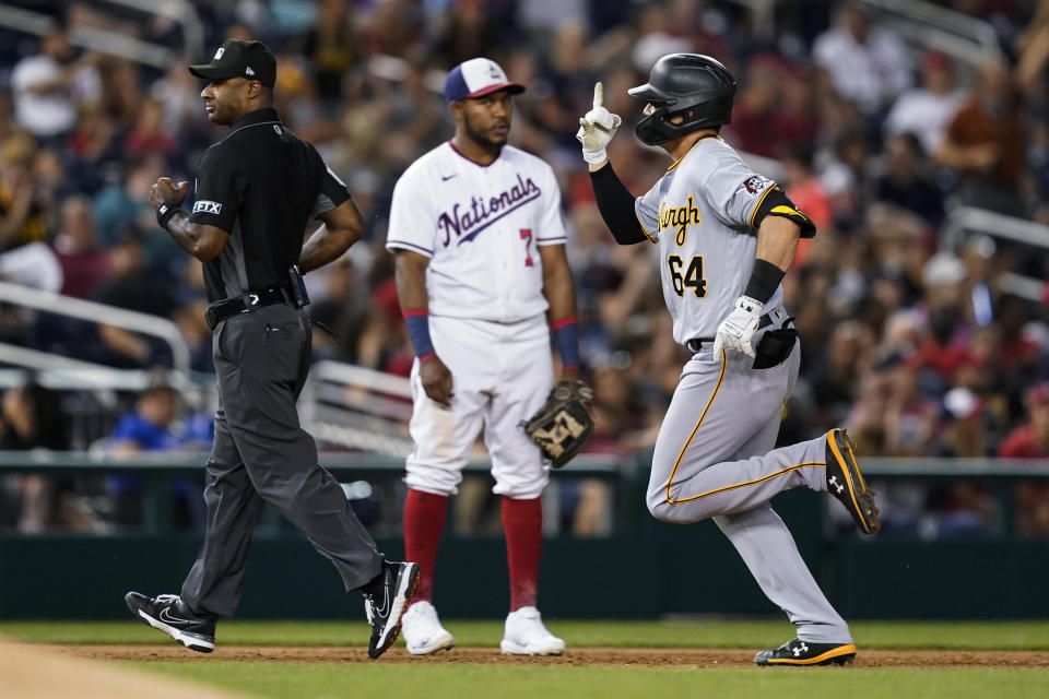 Pittsburgh Pirates' Diego Castillo (64) celebrates as he runs the bases on a solo home run, in front of Washington Nationals third baseman Maikel Franco (7) during the sixth inning of a baseball game at Nationals Park, Tuesday, June 28, 2022, in Washington. (AP Photo/Alex Brandon)