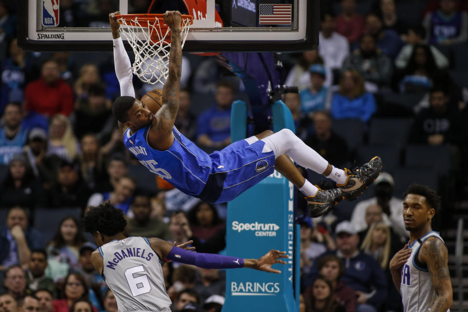 Dallas Mavericks guard Delon Wright dunks above Charlotte Hornets forward Jalen McDaniels (6) during the first half of an NBA basketball game in Charlotte, N.C., Saturday, Feb. 8, 2020. (AP Photo/Nell Redmond)