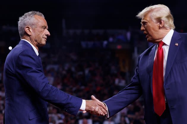 Republican presidential nominee Donald Trump is greeted by Robert F. Kennedy Jr. on stage during an Aug. 23 campaign event at Desert Diamond Arena in Glendale, Arizona.