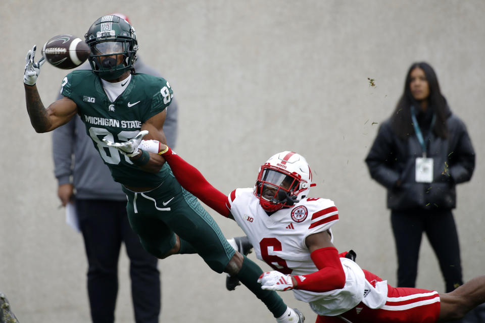 Michigan State wide receiver Montorie Foster Jr., left, catches a 25-yard pass for a touchdown against Nebraska defensive back Quinton Newsome (6) during the second half of an NCAA college football game, Saturday, Nov. 4, 2023, in East Lansing, Mich. (AP Photo/Al Goldis)