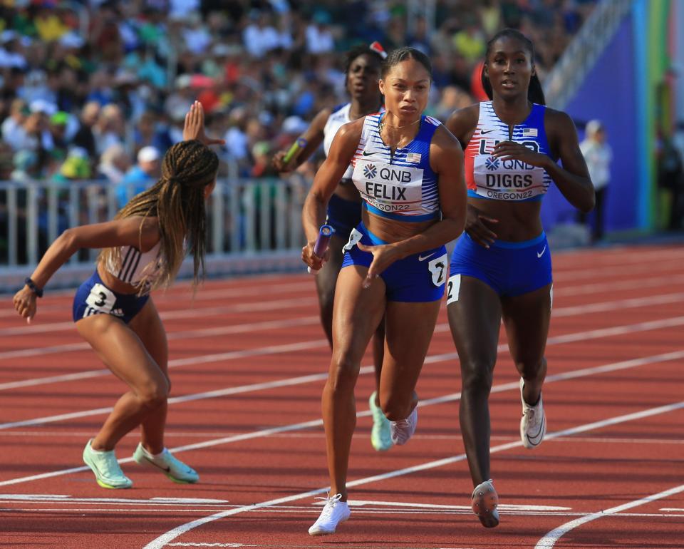 USA's Allyson Felix, center, takes the baton from teammate Talitha Diggs for the second leg of the women's 4x400 meter relay on day nine of the World Athletics Championships at Hayward Field in Eugene, Oregon Saturday July 23, 2022.