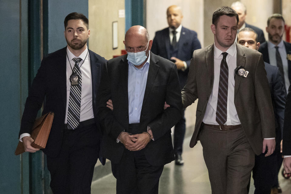 Allen Weisselberg, center, is escorted to Manhattan criminal court, Monday, March 4, 2024, in New York. Weisselberg, the former chief financial officer of the Trump Organization, surrendered to the Manhattan district attorney Monday morning for arraignment on new criminal charges, the prosecutor's office said. (AP Photo/Yuki Iwamura)