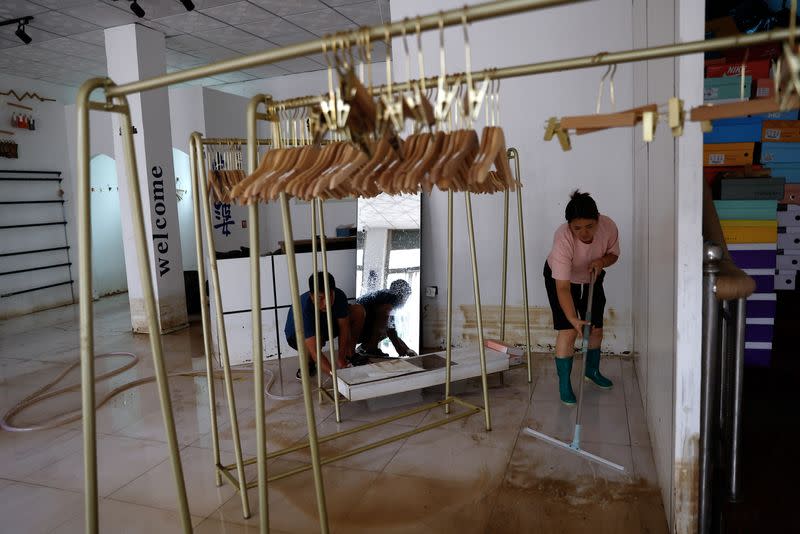 Wang Dan at a clothing store after rain and floods in Zhuozhou