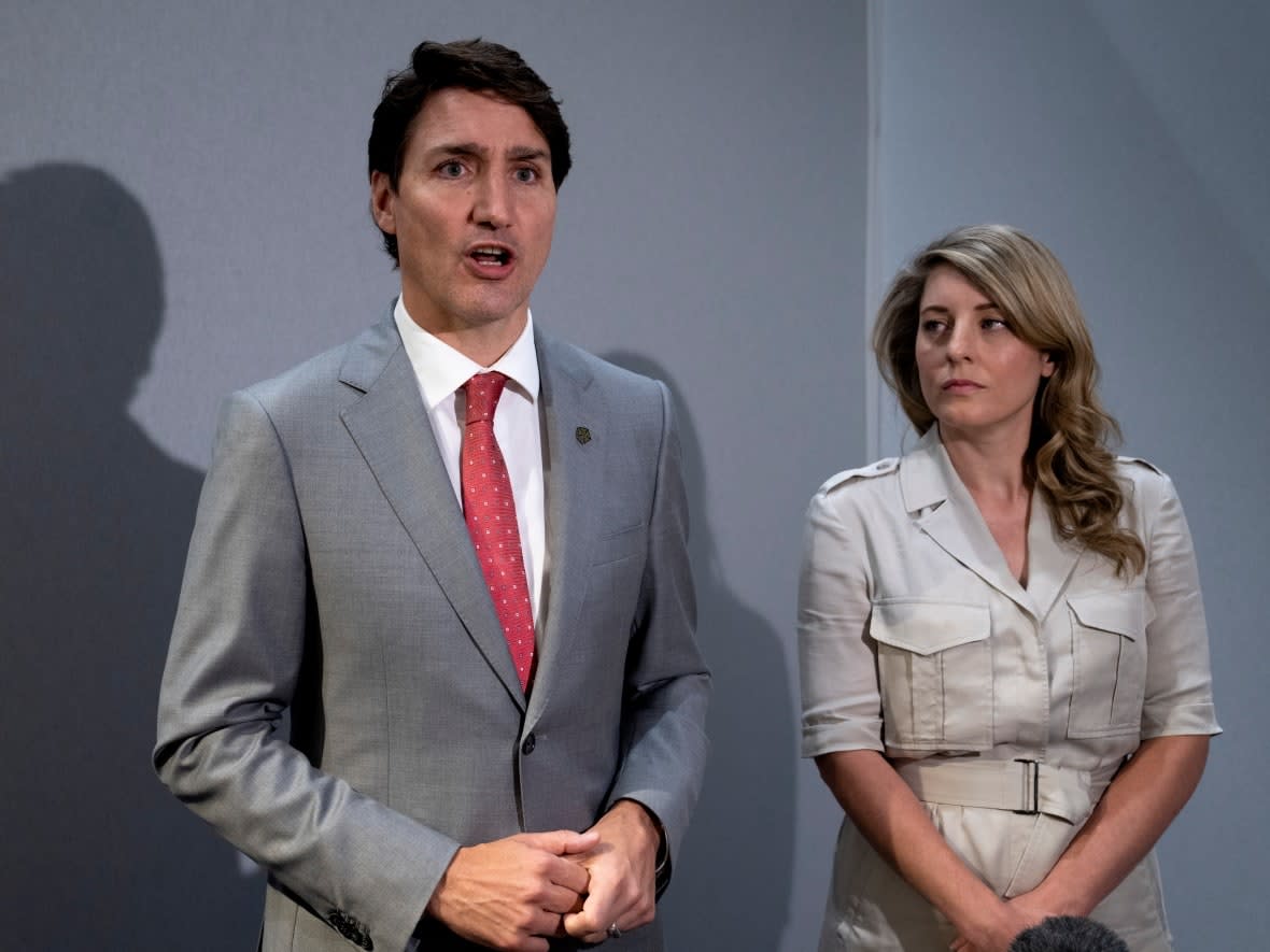 Foreign Affairs Minister Melanie Joly, right, appears next to Canadian Prime Minister Justin Trudeau as they attend the Commonwealth leaders' summit in Kigali, Rwanda, on Friday. (Paul Chiasson/The Canadian Press - image credit)