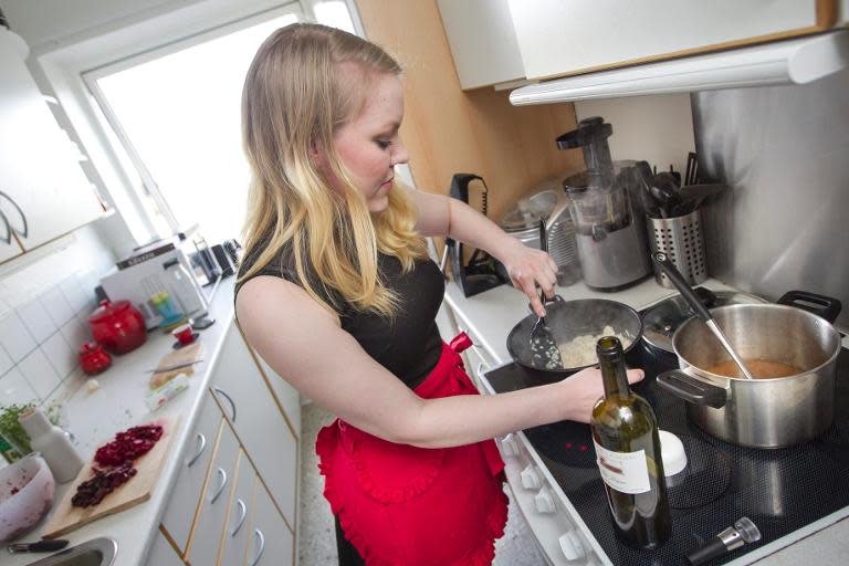 Anne Sofie Udklit Soerensen from Aarhus in Denmark, a member of the DinnerSurfer-community, prepares a meal in her kitchen on April 4, 2014