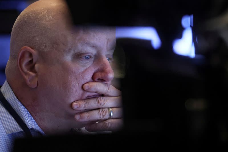 FILE PHOTO: Traders work on the floor of the NYSE in New York