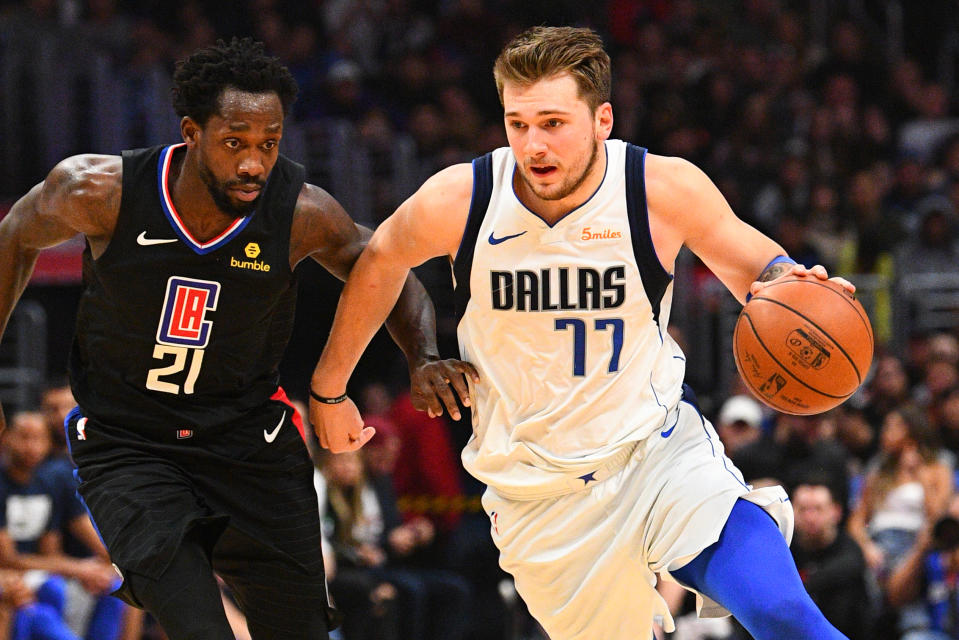 LOS ANGELES, CA - FEBRUARY 25: Dallas Mavericks Guard Luka Doncic (77) drives past Los Angeles Clippers Guard Patrick Beverley (21) during a NBA game between the Dallas Mavericks and the Los Angeles Clippers on February 25, 2019 at STAPLES Center in Los Angeles, CA. (Photo by Brian Rothmuller/Icon Sportswire via Getty Images)