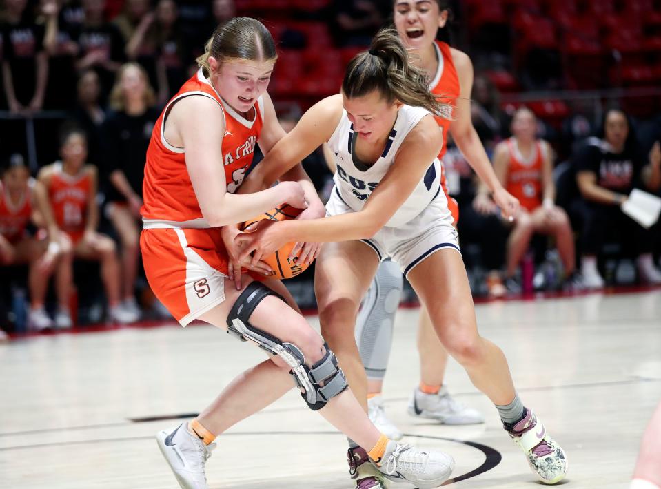 Skyridge’s Cambree Blackham and Syracuse’s Cortnie Barker fight for the ball during a 6A girls quarterfinal basketball game at the Huntsman Center in Salt Lake City on Monday, Feb. 26, 2024. | Kristin Murphy, Deseret News