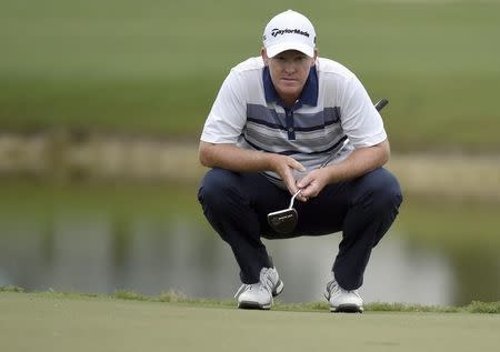 Mar 3, 2016; Miami, FL, USA; Marcus Fraser reads the greens on the ninth green during the first round of the Cadillac Championship at TPC Blue Monster at Trump National Doral. Mandatory Credit: John David Mercer-USA TODAY Sports