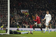 Manchester United's Marcus Rashford, centre celebrates and runs to get the ball after scoring his sides first goal of the game during the English Premier League soccer match between Manchester United and Leeds United at Old Trafford in Manchester, England, Wednesday, Feb. 8, 2023. (AP Photo/Dave Thompson)