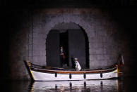 British violinist Daniel Hope gets on a small boat to arrive for his concert set on a floating stage on the Vltava river in Prague, Czech Republic, Saturday, Sept. 19, 2020. The Czech Republic has been been facing the second wave of infections of COVID-19. The number of new confirmed coronavirus infections has been setting new records almost on a daily basis. The Prague Castle is in the background. (AP Photo/Petr David Josek)