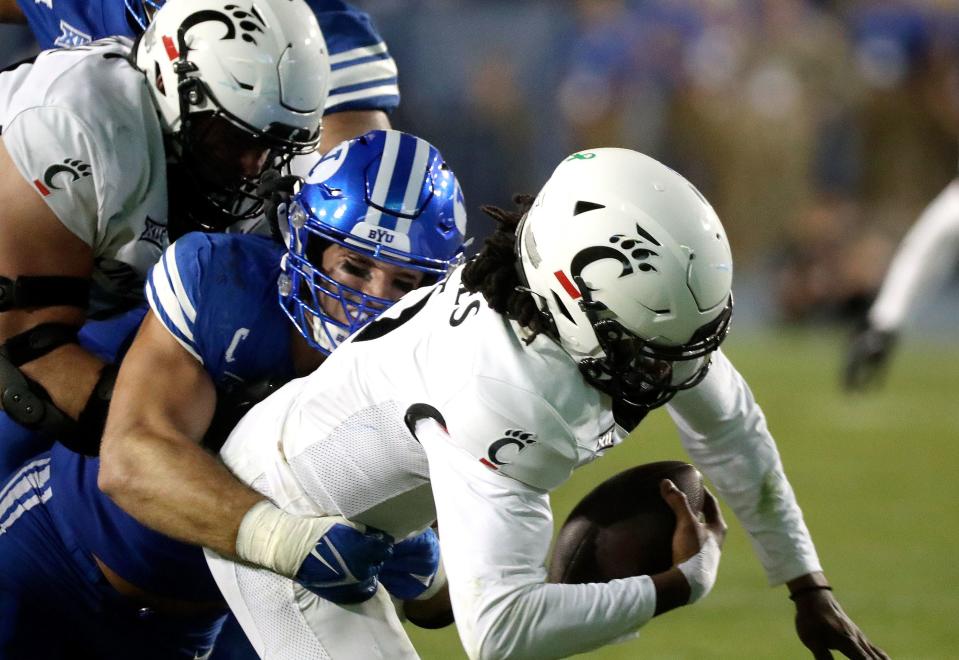 Brigham Young Cougars defensive end Tyler Batty (92) sacks Cincinnati Bearcats quarterback Emory Jones (5) during the second half of a football game at LaVell Edwards Stadium in Provo on Friday, Sept. 29, 2023. BYU won 35-27. | Kristin Murphy, Deseret News