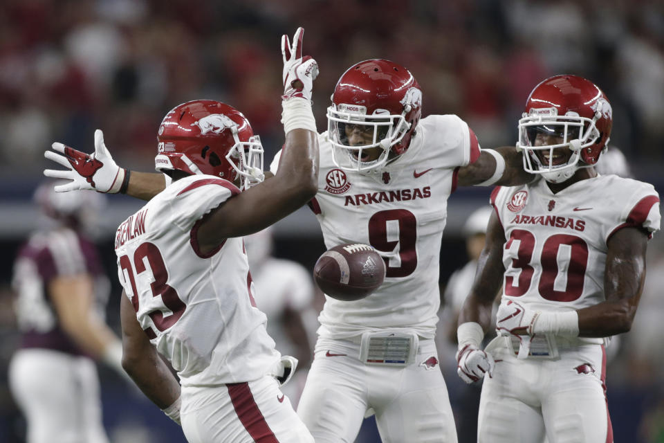 Sep 29, 2018; Arlington, TX, USA; Arkansas Razorbacks linebacker Dre Greenlaw (23) celebrates making his second interception of the game with Arkansas Razorbacks defensive back Santos Ramirez (9) and defensive back Kevin Richardson II (30) in the second quarter against the Texas A&M Aggies at AT&T Stadium. Mandatory Credit: Tim Heitman-USA TODAY Sports