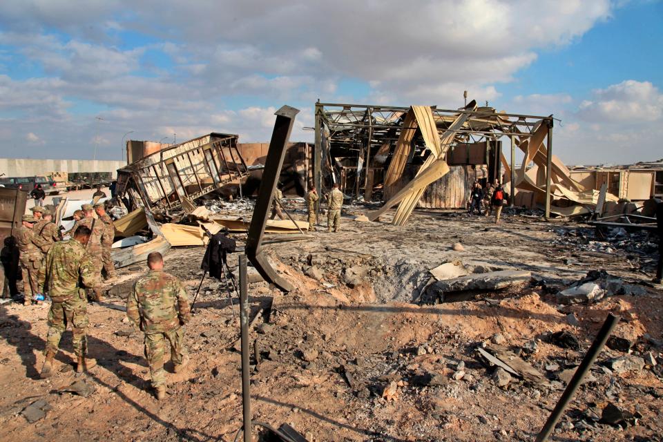 U.S. soldiers stand at the spot hit by Iranian bombing at Ain al-Asad air base, in Anbar, Iraq.