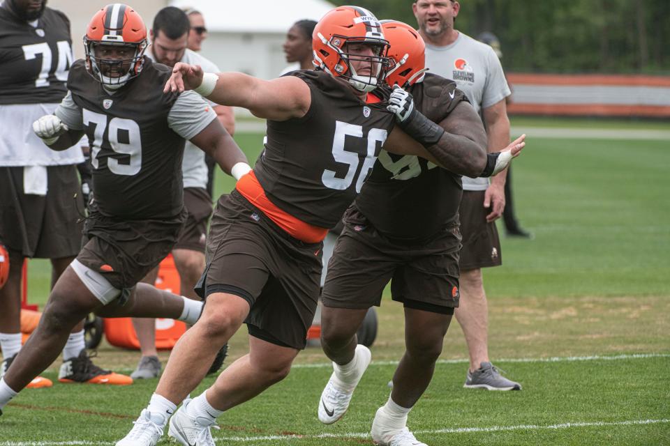 Luke Wypler (56) runs a drill as Tyrone Wheatley (79) looks on at Browns rookie minicamp May 12 in Berea.