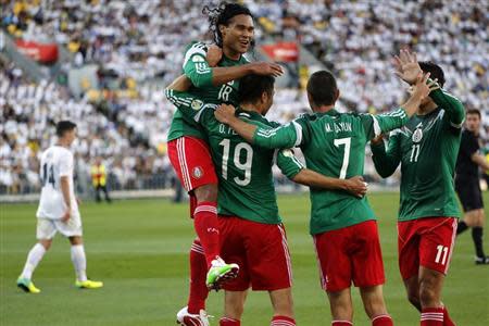 Mexico's players celebrate a goal by Oribe Peralta during their 2014 World Cup qualifying playoff second leg soccer match against New Zealand at Westpac Stadium in Wellington November 20, 2013. REUTERS/Anthony Phelps