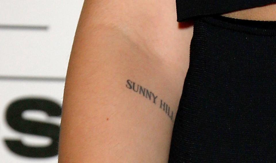 A closeup of the tattoo, which is printed in simple font just below Dua's elbow