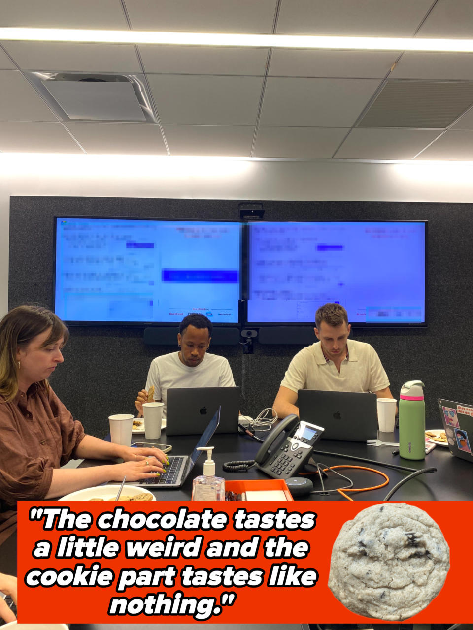 Three people sitting at a conference room table with drinks and cookies, caption reads: "This particular cookie is just too thick and hard. I'd only serve this to my nemesis."