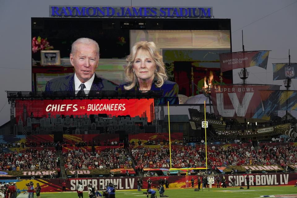 President Joe Biden and first lady Dr. Jill Biden are seen on a scoreboard screen delivering a message before the NFL Super Bowl 55 football game between the Kansas City Chiefs and Tampa Bay Buccaneers, Sunday, Feb. 7, 2021, in Tampa, Fla. (AP Photo/Chris O'Meara)