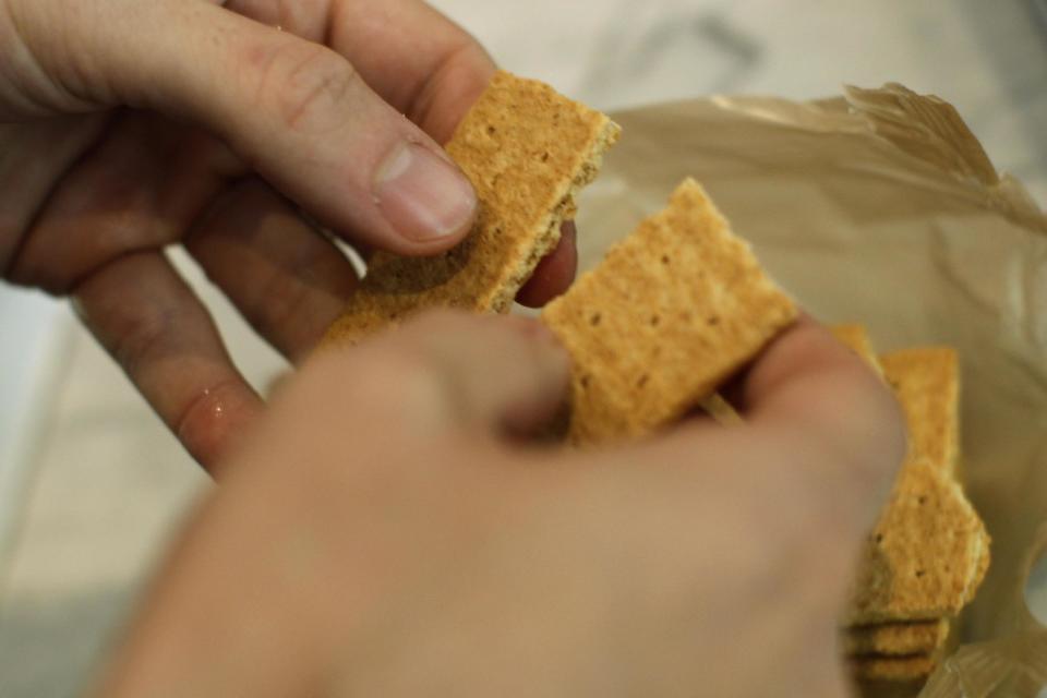 In this May 7, 2012 photo, "Top Chef" star Spike Mendelsohn breaks apart a graham cracker as he prepares a specialty milkshake at his new Good Stuff Eatery restaurant in Crystal City, Arlington, Va. (AP Photo/Charles Dharapak)