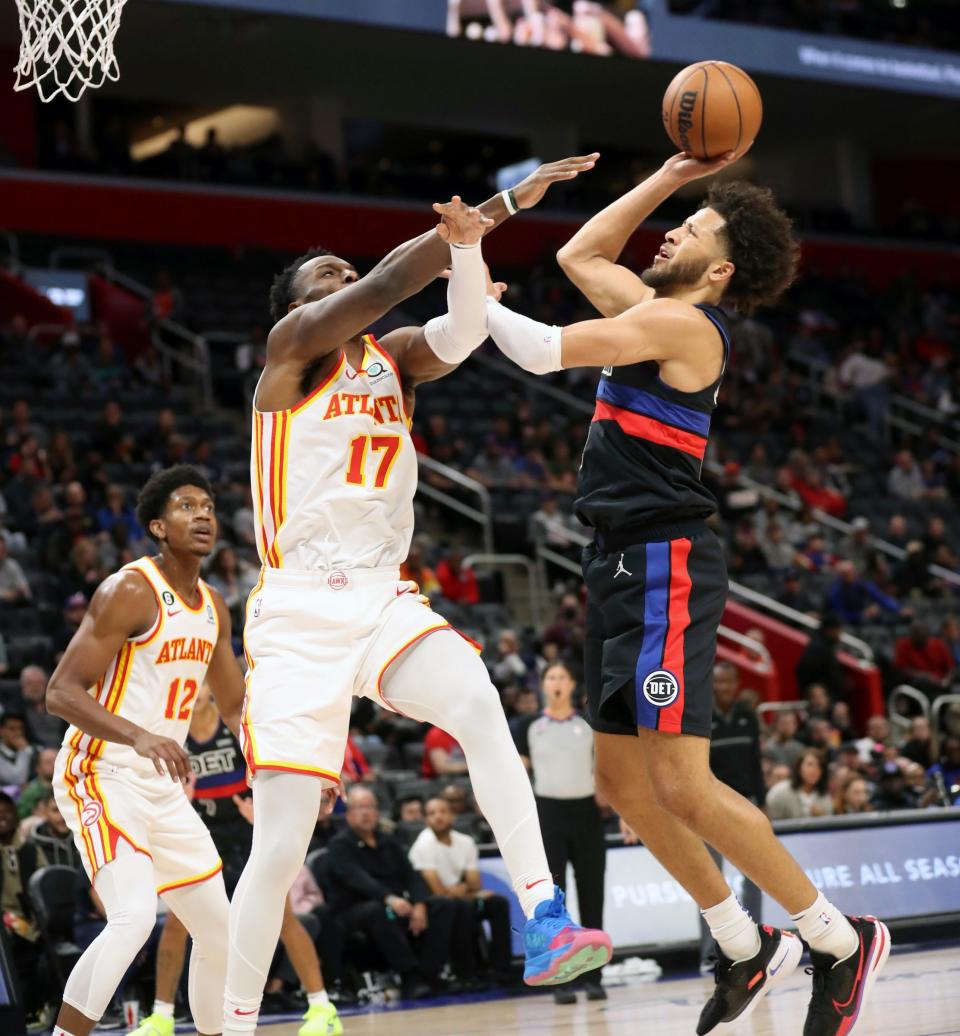 Detroit Pistons guard Cade Cunningham (2) scores against Atlanta Hawks forward Onyeka Okongwu (17) during first-quarter action on Wednesday, Oct. 26, 2022, at Little Caesars Arena in Detroit.
