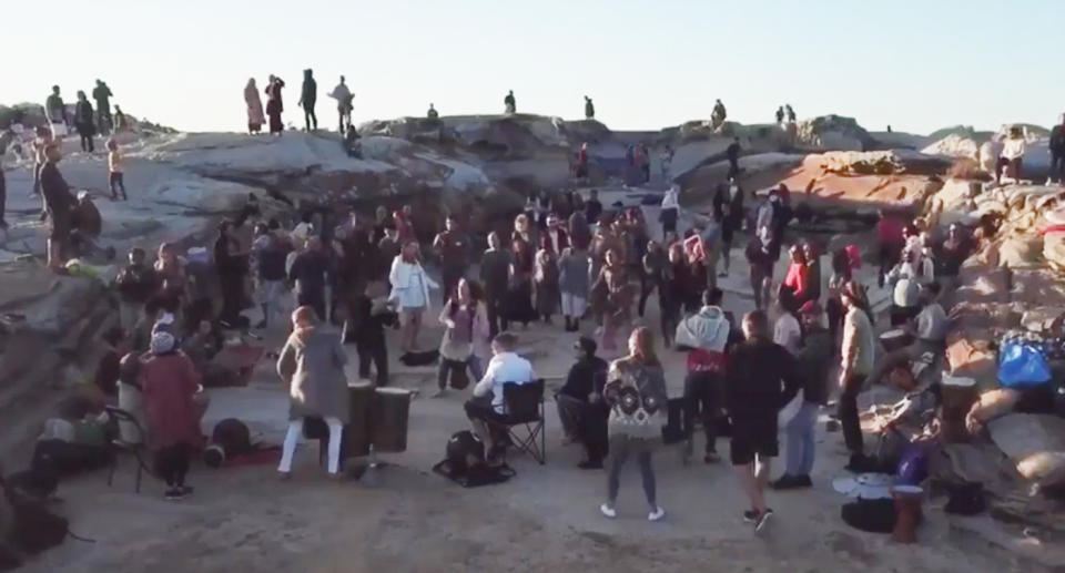 A still from an online video shows people dancing at a gathering on Maroubra beach.