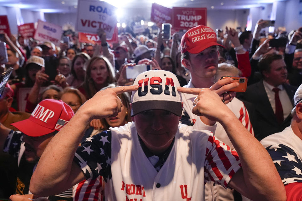 FILE - Supporters cheer as Republican presidential candidate former President Donald Trump speaks at a primary election night party at the South Carolina State Fairgrounds in Columbia, S.C., Feb. 24, 2024. A new survey provides a sobering outlook of the world's democracies. While most citizens in two dozen countries say representative democracy is a good way to govern, they are deeply dissatisfied with the way it's working in their country. (AP Photo/Andrew Harnik, File)