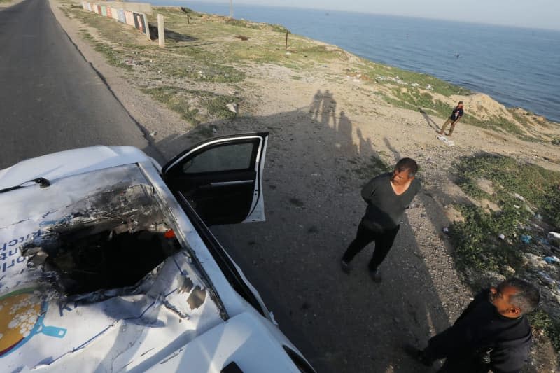 Palestinians inspect the heavily damaged vehicle after the Israeli attacks target officials working ta the US-based international volunteer aid organization World Central Kitchen (WCK). Omar Ashtawy/APA Images via ZUMA Press Wire/dpa