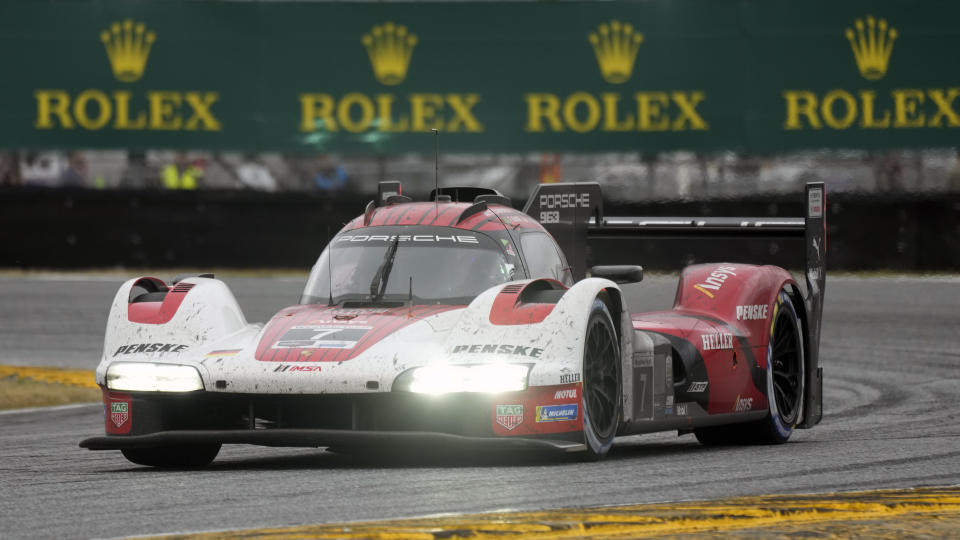 Felipe Nasr, of Brazil, drives his Porsche 963 through a turn during the Rolex 24 hour auto race at Daytona International Speedway, Sunday, Jan. 28, 2024, in Daytona Beach, Fla. (AP Photo/John Raoux)